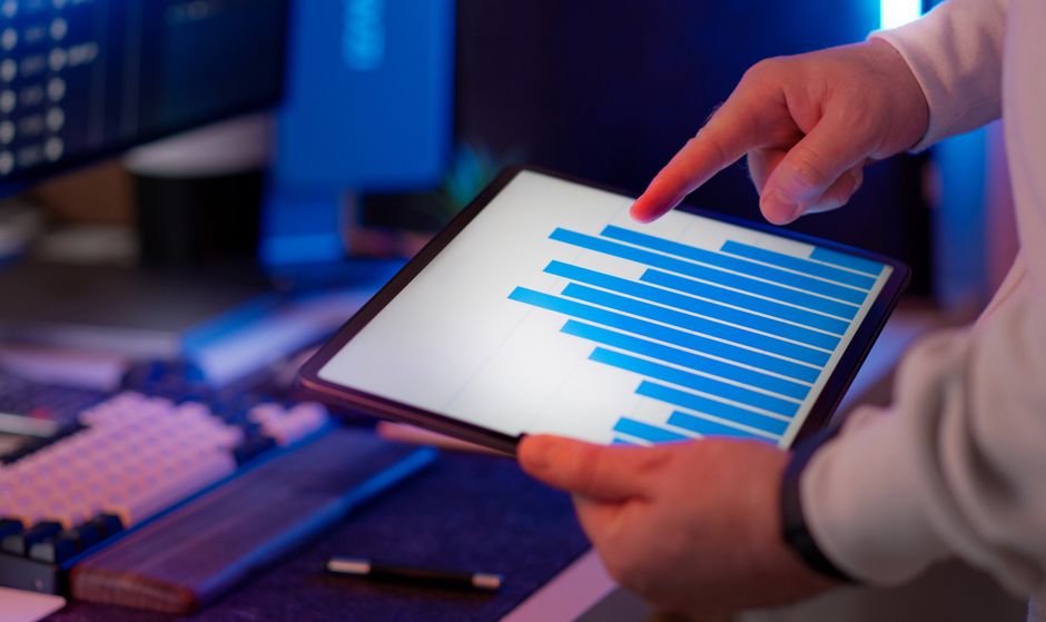 Business professional reviewing analytics charts on a tablet